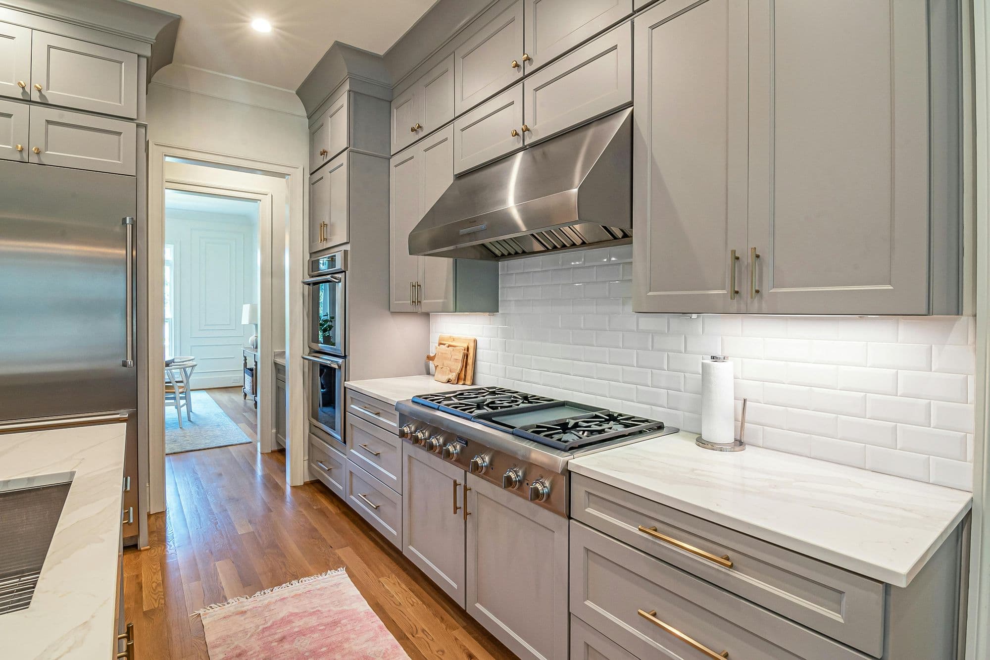 Kitchen with painted gray shaker cabinets and brass hardware
